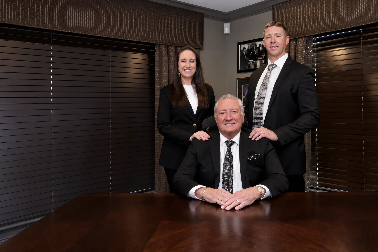 Hillis leadership team with Bob Hillis seated between Laura and Jason Solomon
